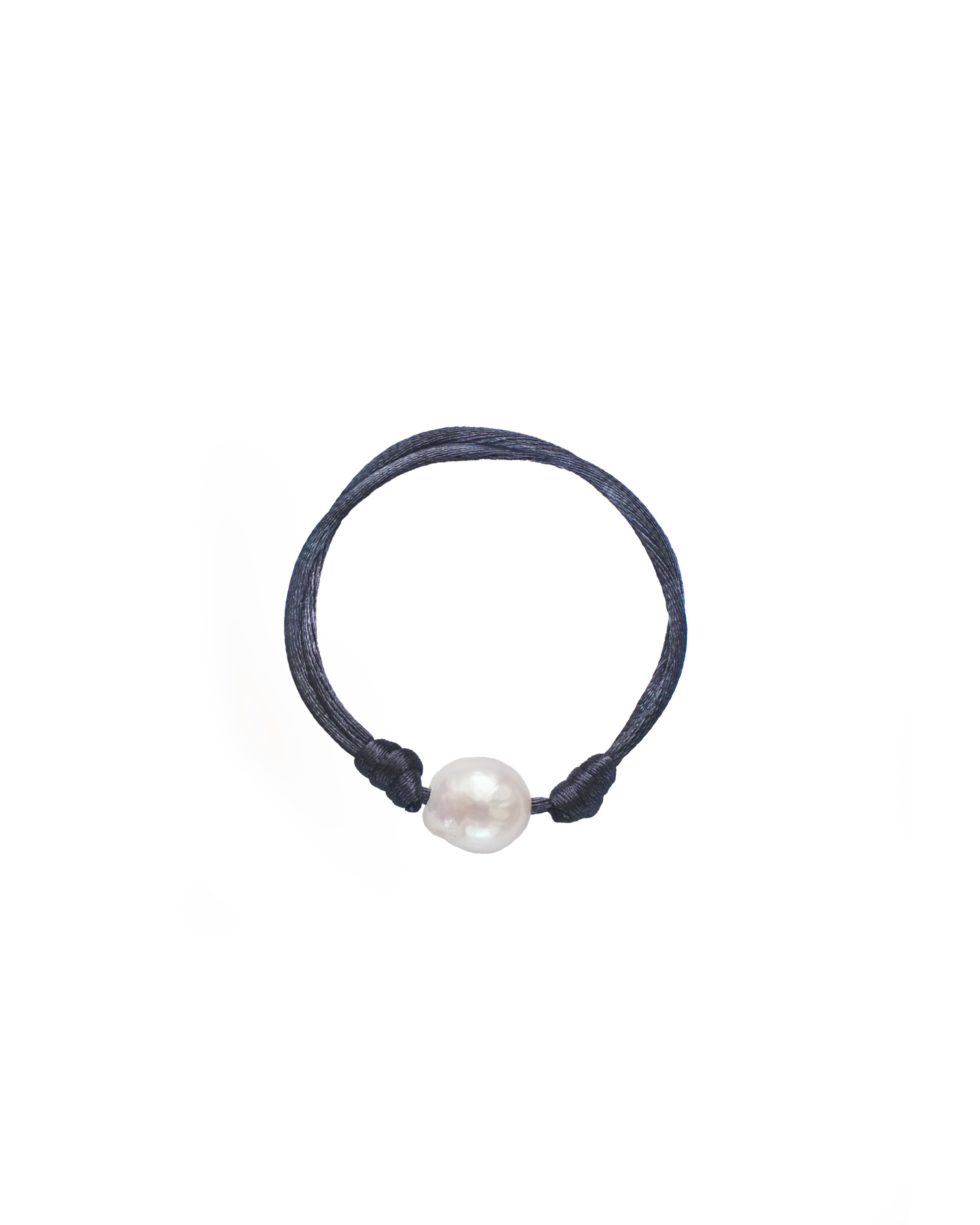 Navy blue hair tie with a white pearl on a white background