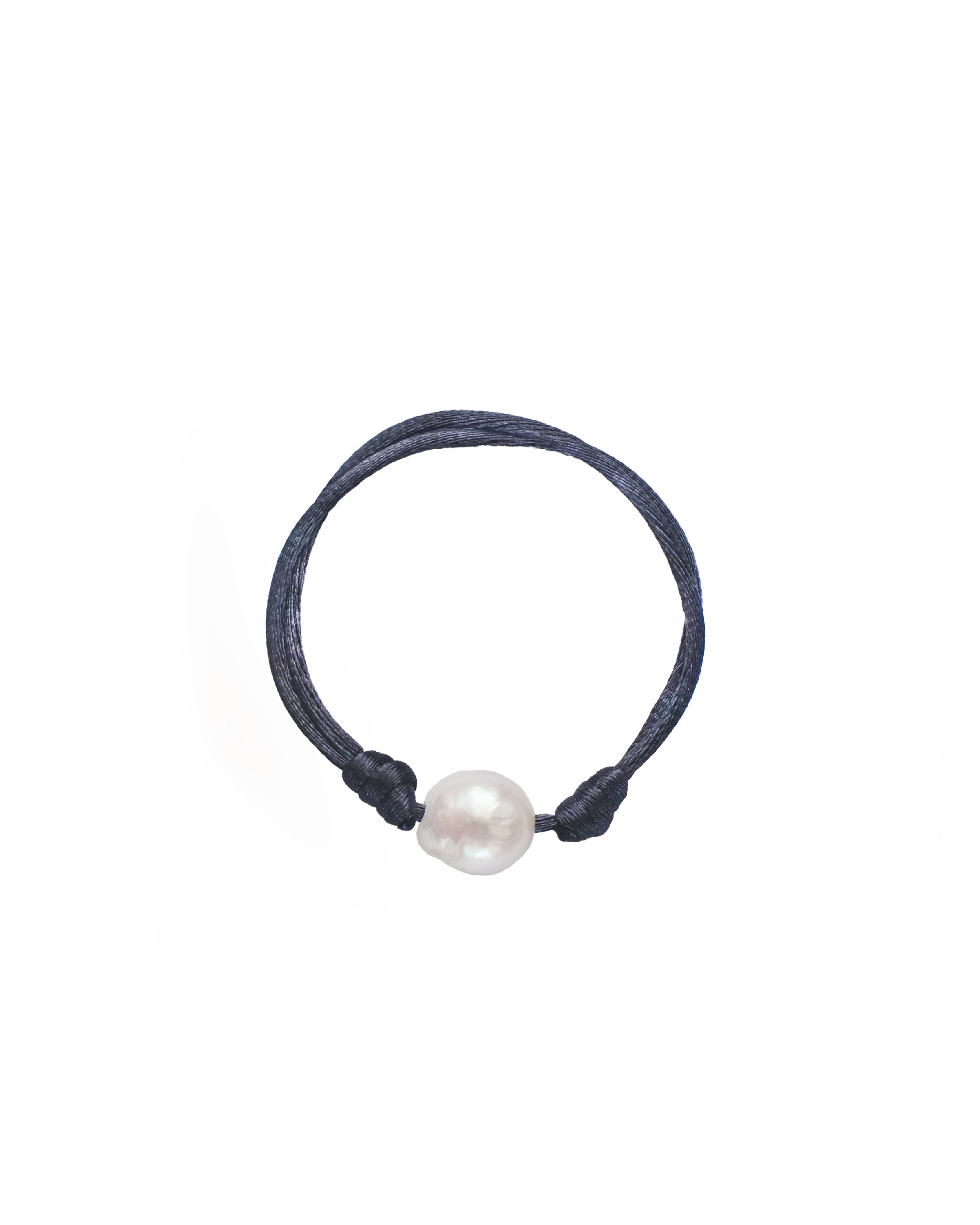 Navy blue hair tie with a white pearl on a white background