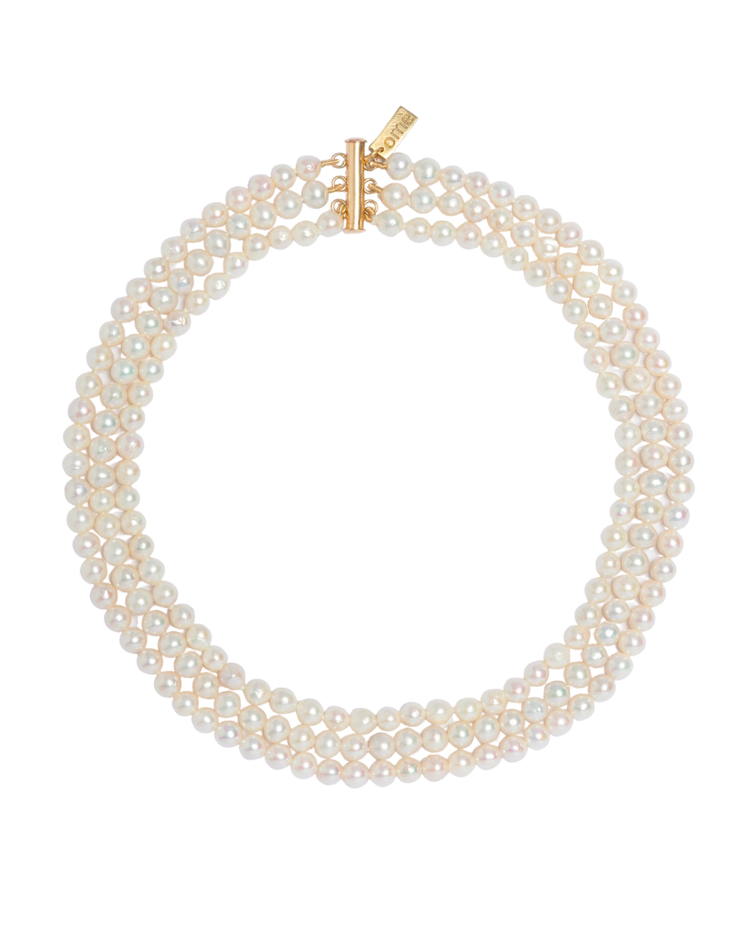 A necklace with three strands of freshwater pearls and a gold-filled closure.